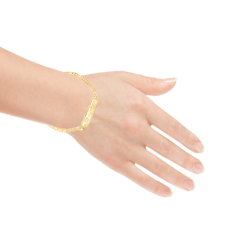 A hand adorned with the I LOVE YOU plate Baby Bracelet with mariner link, made of 14K gold filled material, posed gracefully against a white background.